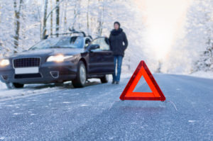 Woman beside her car in snow